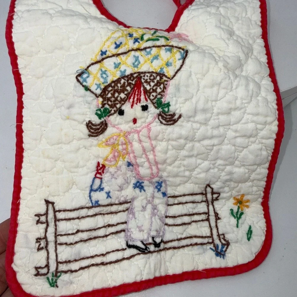 Vtg handmade quilted baby bib embroidered girl in a hat sitting on a fence
